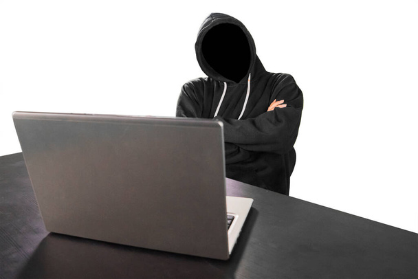 Unknown programmer looks thinking with laptop on the table, isolated on white background - Photo, Image