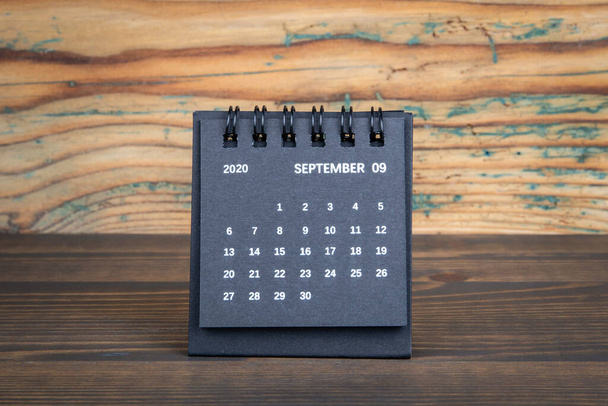 2020 AUGUST. Black paper calendar on a wooden table. Time planning, day counting and holidays - Valokuva, kuva