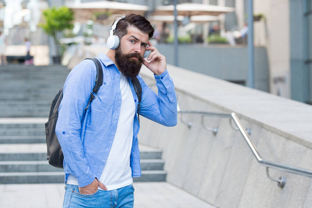 Engineered for modern life. Bearded man wear headphones outdoors. Listening to music in modern age. Hi-Fi audio. Digital sound. Modern technology. Modern lifestyle - Photo, Image