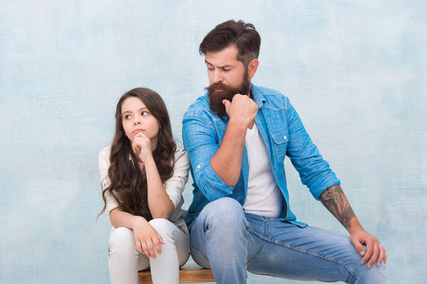 Be what you want to be and wear what you like. Bearded man look at small child. Father and daughter sit on stool. Fashion wear. Casual style. Fashion trends. Trendy style. Hair salon. Barbershop - Фото, зображення