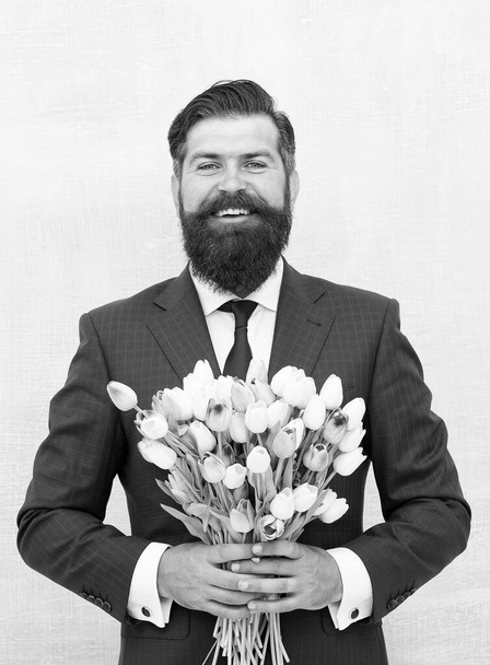 Express positivity. celebrate birthday party. businessman hold flowers gift. happy man ready for love date. valentines day holiday. spring is here. for my mother at mothers day. happy womans day - Fotografie, Obrázek
