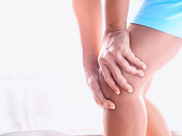 Young Asian Thai women with body aches suffering muscle injury with knee pain and leg pain - Fotó, kép