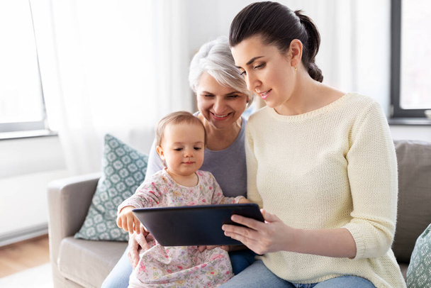 mother, daughter and grandma with tablet pc - Фото, изображение