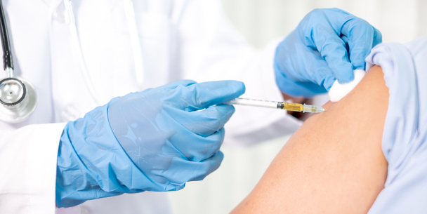 Female doctors vaccinated with syringes to prevent epidemics at hospitals, health care, and medical concepts. - Photo, image