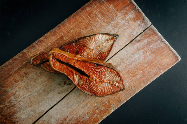 Slice of smoked salmon on vintage  cutting board - Fotografie, Obrázek