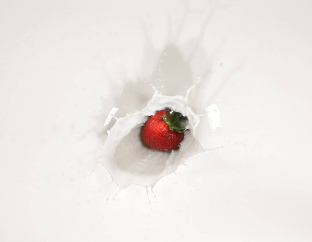 Strawberry falling in milk with splash, top view - Φωτογραφία, εικόνα