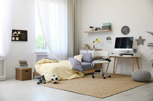 Stylish teenager's room interior with comfortable bed and workplace - Fotografie, Obrázek