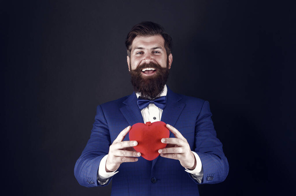 Love is in the air. brutal bearded hipster in formal outfit. confident successful businessman in suit with bow tie. happy valentines day. tuxedo man with red heart. love and romance. ready for date - Fotoğraf, Görsel