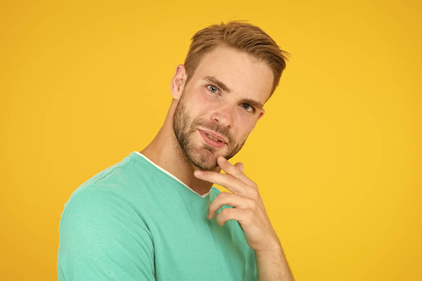Think about. Self care. Handsome man yellow background. Well groomed guy with bristle and nice hairstyle. Male beauty. Barber hairdresser salon. Bearded man. Skin care. Facial care. Keep youth - Zdjęcie, obraz