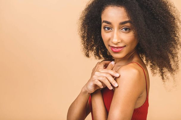 Beauty skin closeup profile portrait of beautiful mixed race caucasian - african american woman looking at camera, isolated on beige background. - Foto, immagini