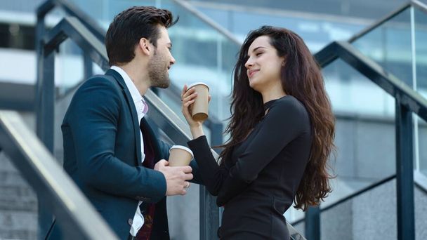 Closeup business couple standing with coffee. Business man and woman talking - Photo, Image