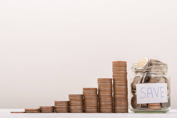 Saving Money, Coin in glass bottle with money stack. financial business investment Concept. - Fotoğraf, Görsel