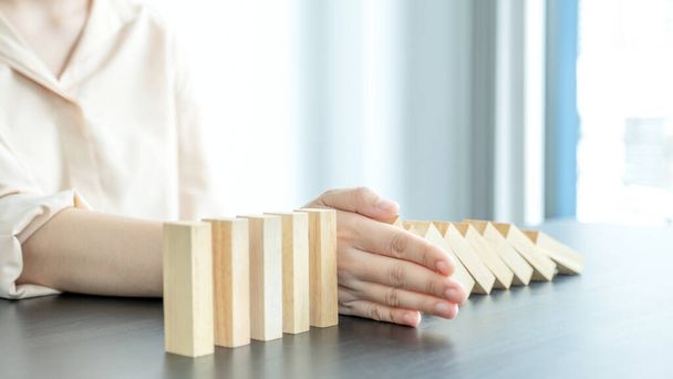 Woman hand stop wooden blocks for protect other wooden block, Concept Risk of management and strategy plan. - Foto, Imagen