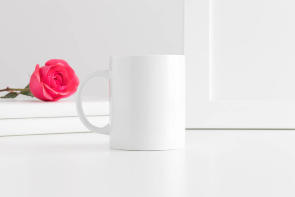 Mug mockup with books and a pink rose on a white table. - Photo, Image