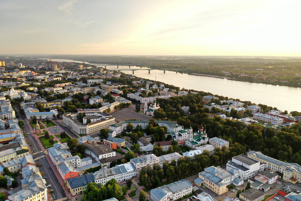 a large city with churches from the embankment along the river filmed from a drone - Photo, Image