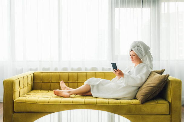 Woman is relaxing with mobile phone. - Photo, Image