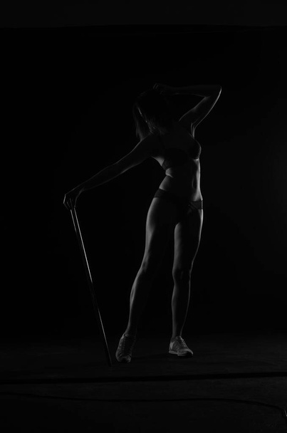 silhouette of beautiful woman with short hear in lingerie posing on dark studio background     - Zdjęcie, obraz