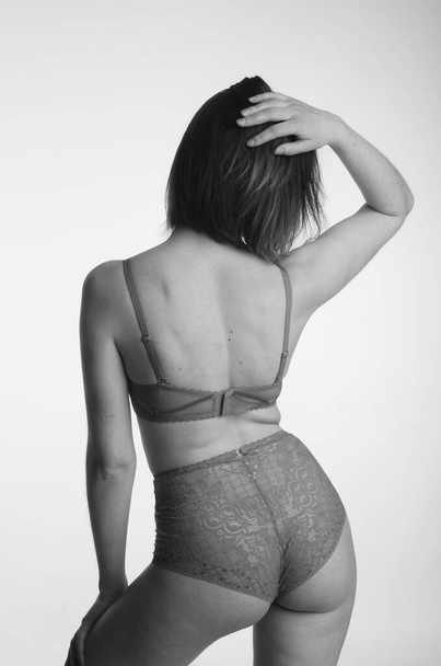 beautiful woman with short hear in lingerie posing on light studio background    - Valokuva, kuva
