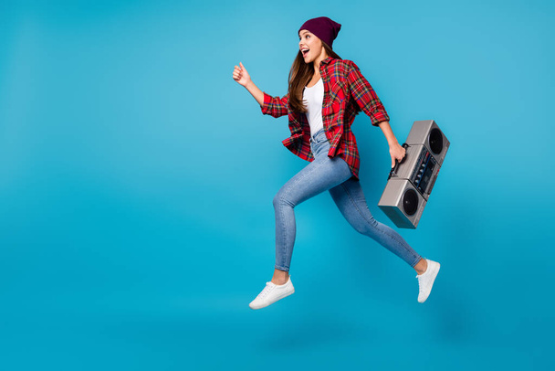 Full length body size view of her she nice attractive pretty glad sporty cheerful girl jumping carrying boombox running isolated over bright vivid shine vibrant blue color background - Foto, Imagem