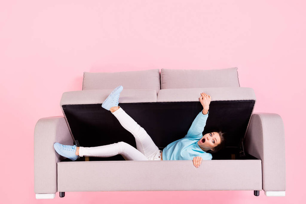 Top view above high angle flat lay flatlay lie concept of her she nice attractive pretty helpless worried girl lying inside divan trying to get out isolated over pink pastel color background - Foto, Imagem