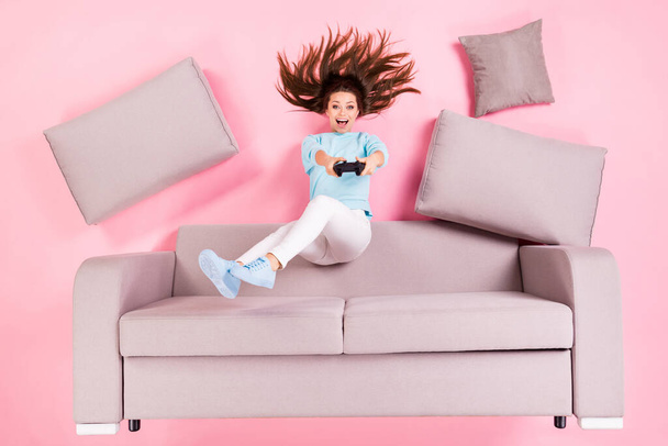 Top view above high angle flat lay flatlay lie concept of her she nice attractive cheerful cheery addicted girl sitting on divan having fun playing video station isolated pink pastel color background - Photo, Image