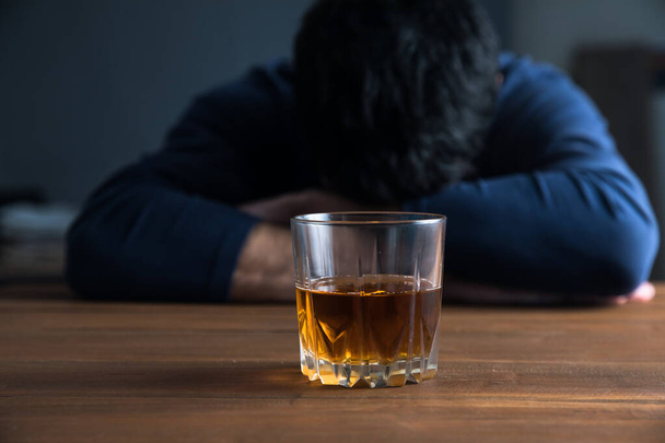 sad man hand alcohol glass on des - Фото, зображення