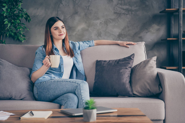 Portrait of nice pretty content girl sit divan hold cappuccino beverage mug enjoy free time holiday look in house indoors apartment - Valokuva, kuva
