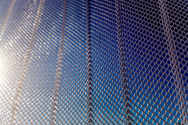 δίχτυ από νάιλον προστατεύει ένα καλοκαιρινό παράθυρο από κουνούπια και έντομα, λεπτομέρεια close up. - Φωτογραφία, εικόνα