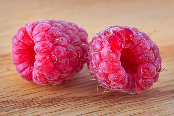 Bright  crimson raspberry on the wooden backgriund - Photo, Image