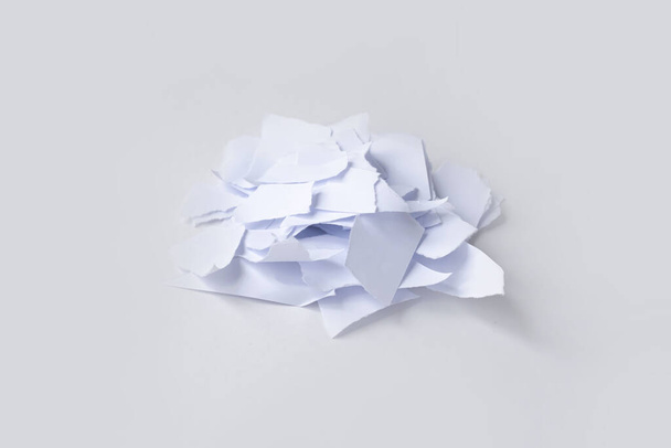 A pile of torn into small pieces of white paper on a white background. isolated. - Foto, Imagem