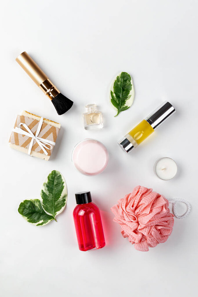 Cosmetics and self-care. A composition of Cosmetics, leaves and accessories lie on a white background. The concept of organic and natural cosmetics. Flat lay. - Фото, зображення