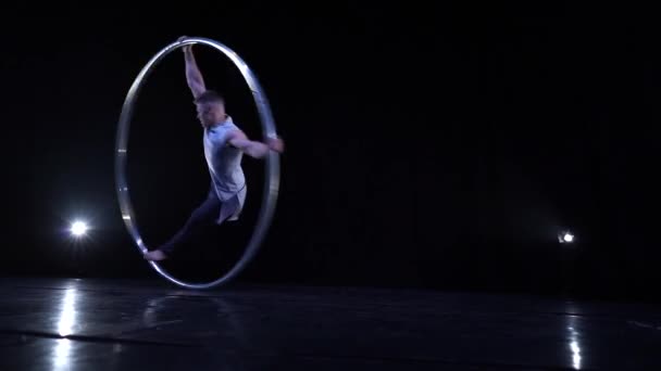 Muscular Circus artist spinning on a Cyr wheel in slow motion. Concept of movement, motion and balance - Felvétel, videó