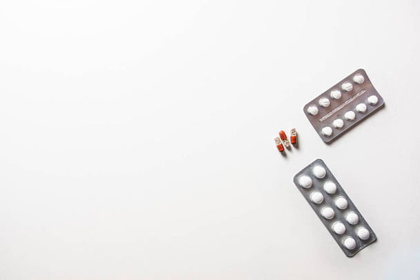 different medicine pills in packs on white desk - Φωτογραφία, εικόνα