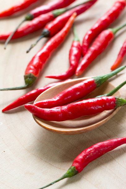 red chili pepper on wooden table,closeup view - Photo, Image