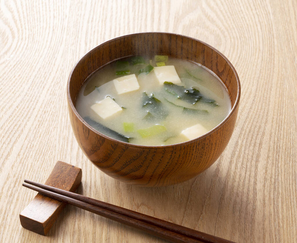 Zuppa Miso con tofu e alghe wakame su un tavolo di legno - Foto, immagini