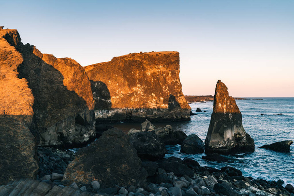 Marvelous sunset on popular tourist attraction Valahnukamol bay in southern Iceland. Cliffs are located in Reykjanes peninsula and are easily accessible from Keflavik or Reykjavik the capital city - Photo, image
