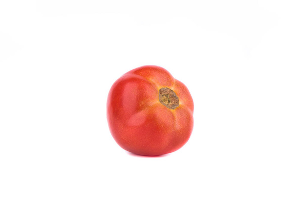 Ripe red tomato lying on its side over a white background. Close up. Copy space. - Fotoğraf, Görsel
