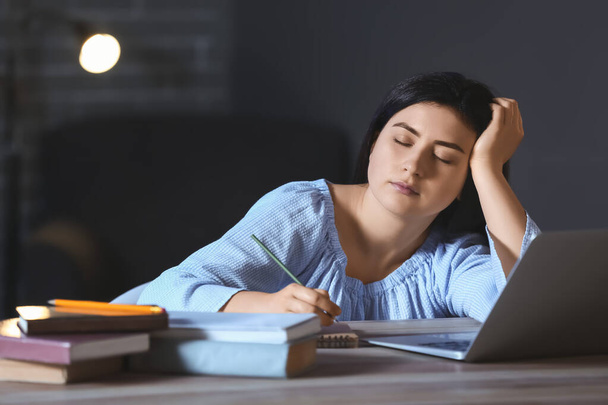 Student sleeping at table late in evening - Photo, Image