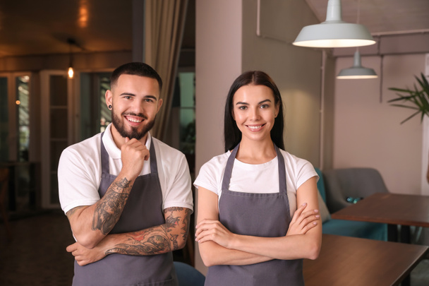 Portrait of young waiters in restaurant - Photo, Image
