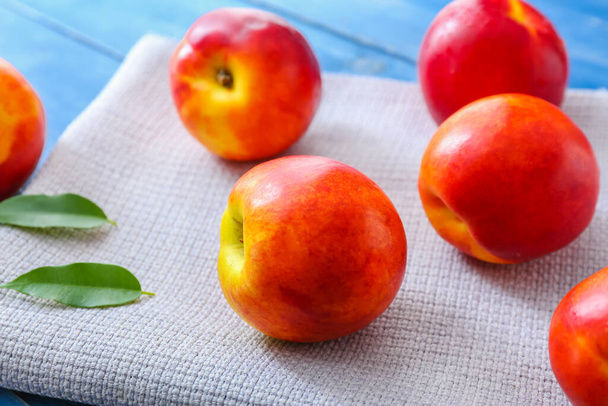 Sweet ripe nectarines on table - Фото, зображення
