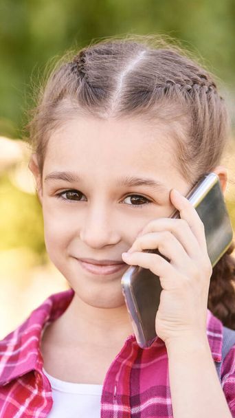 Cute little girl talking. Hold phone near face - Foto, Imagen