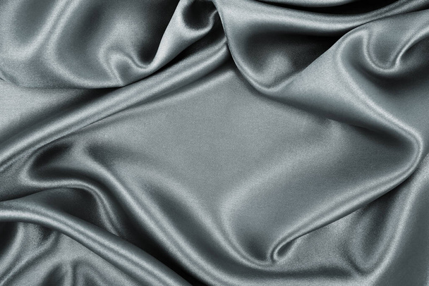 Smooth elegant dark grey silk or satin texture can use as abstract background. Luxurious background design - Фото, зображення