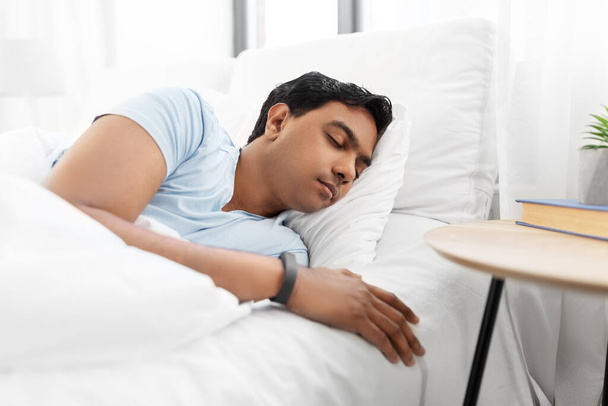 indian man sleeping in bed at home - Fotó, kép