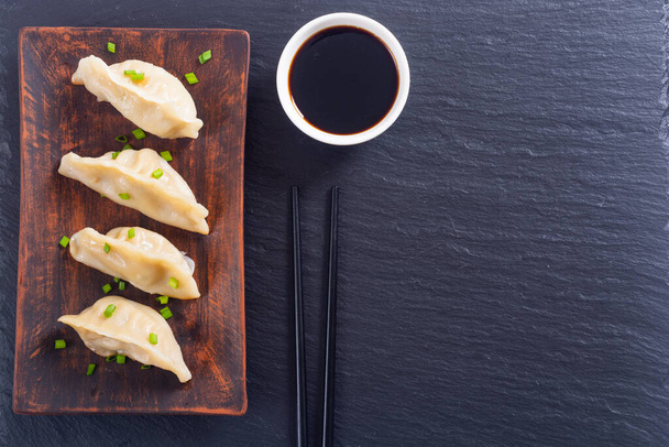 Traditional asian dumplings gyoza with green onion and soy sauce - Photo, image
