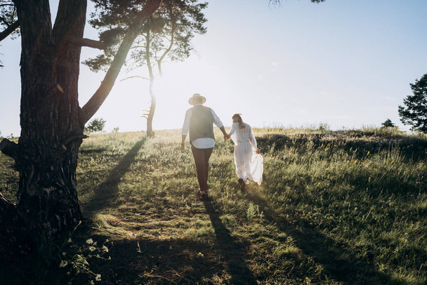 beautiful woman in white dress with handsome man walking in the park - Photo, image