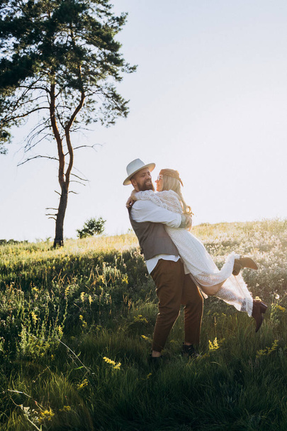 beautiful woman in white dress with handsome man hugging  in the park - Foto, immagini