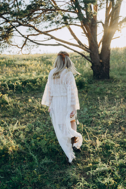 adult attractive woman in long white dress walking    in the field  - Foto, Imagem