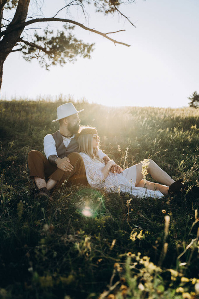 beautiful woman in white dress with handsome man  sitting on the lawn - Φωτογραφία, εικόνα
