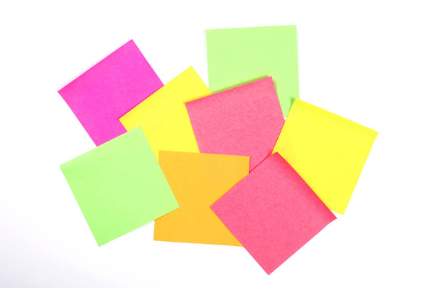 group of blank colorful paper sticky notes isolated on white wall with copy space for your text - Photo, Image