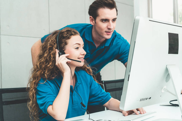 Business people wearing headset working in office to support remote customer or colleague. Call center, telemarketing, customer support agent provide service on telephone video conference call. - Φωτογραφία, εικόνα